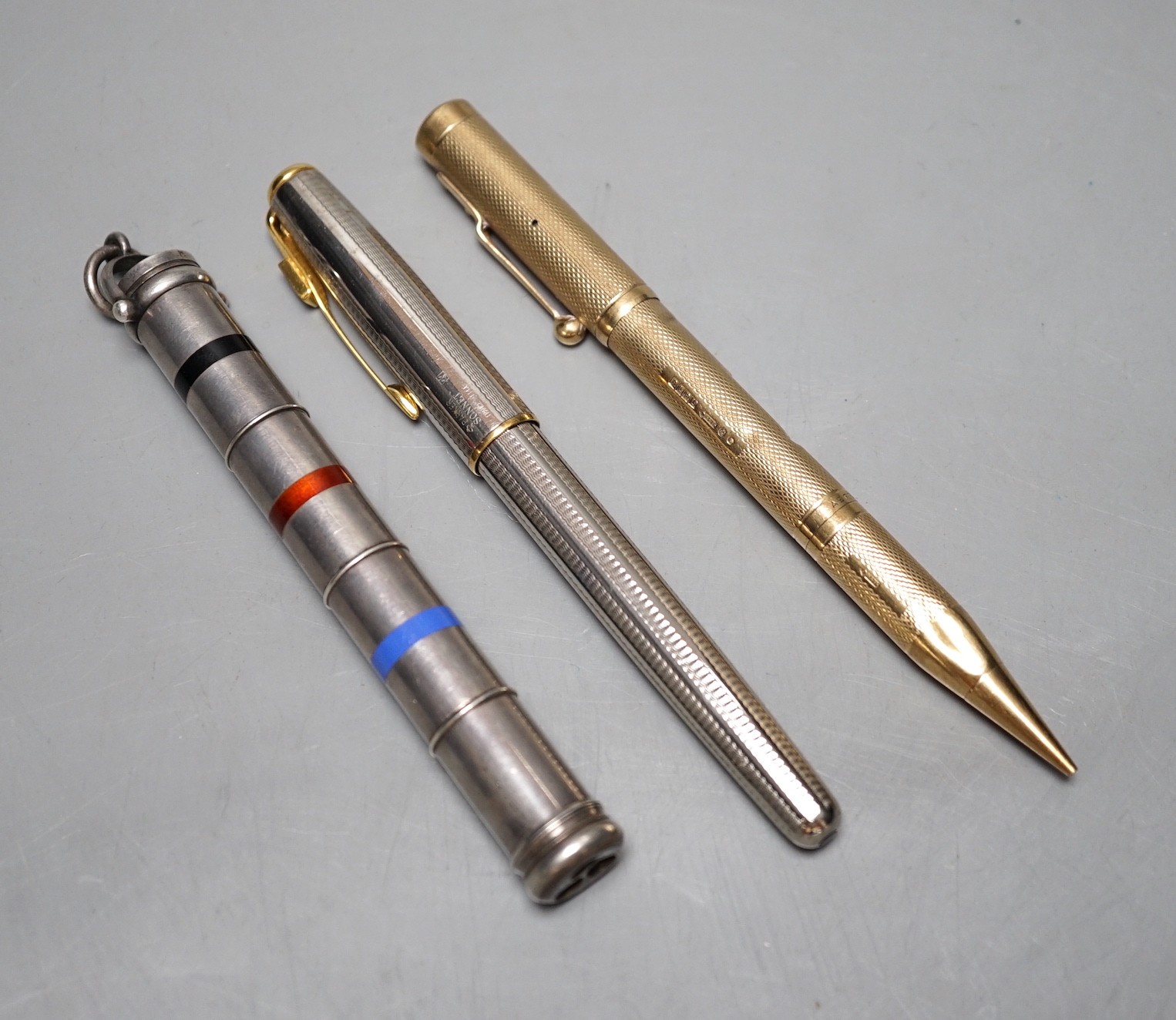 A 9ct yellow gold double ended Asprey pencil and fountain pen, a multi-colour propelling pen and one other (3)